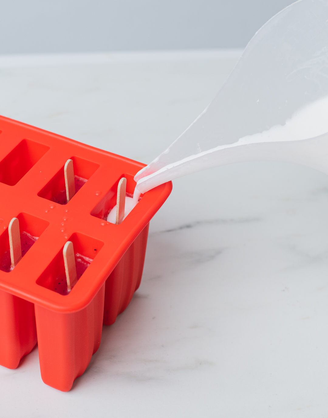 Pouring soap into silicone mold.