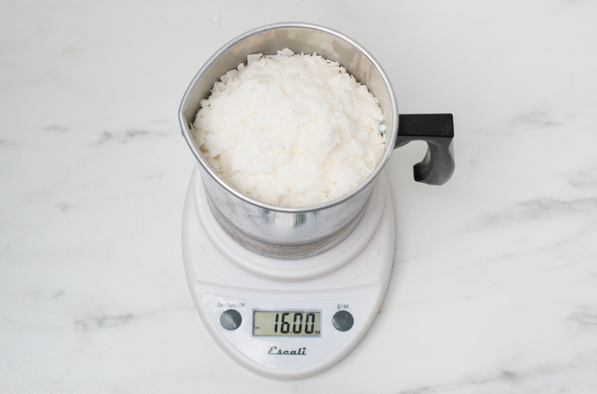 Wax flakes weighed on a digital scale.