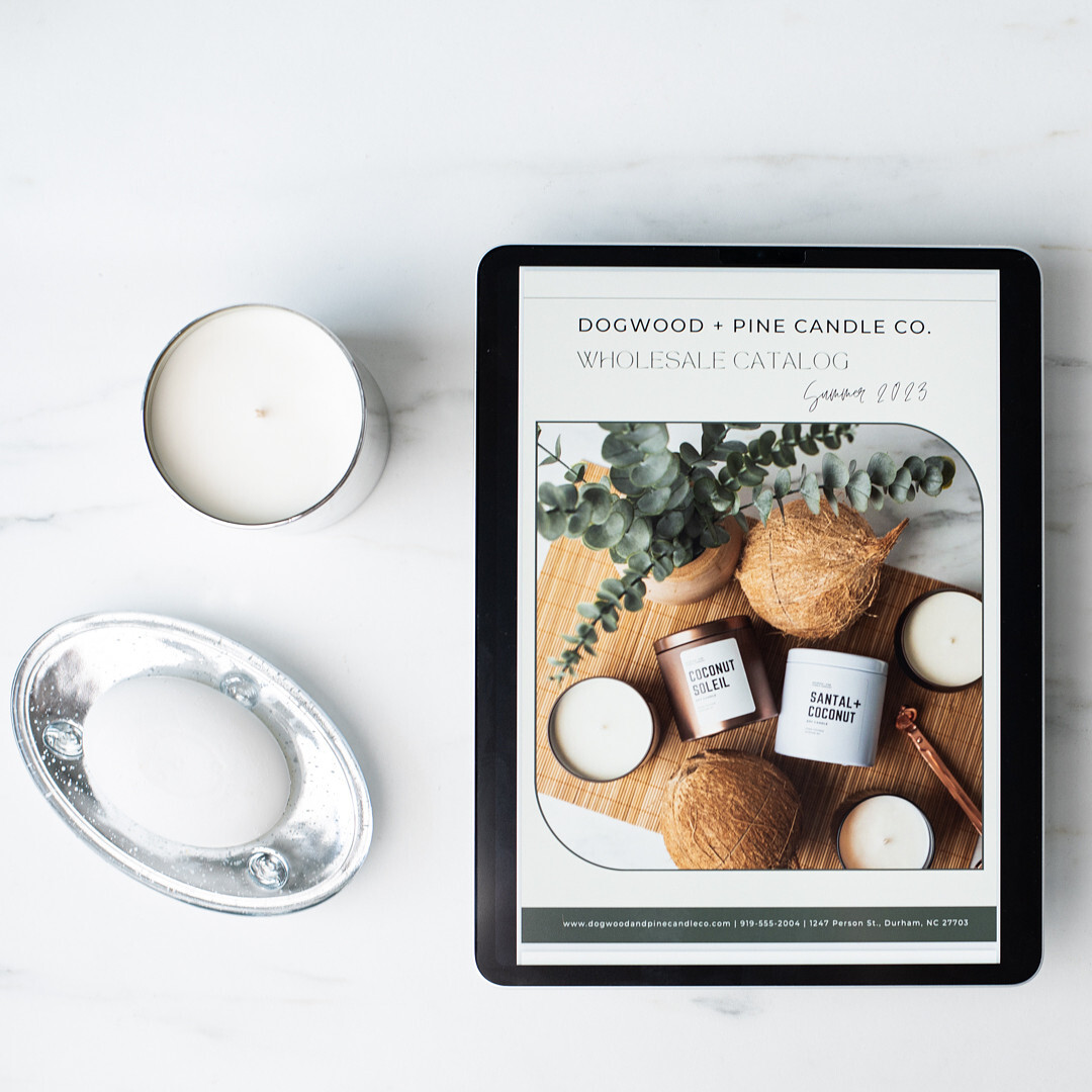 An iPad screen displays the front cover of a wholesale line sheet for Dogwood + Pine Candle Co.