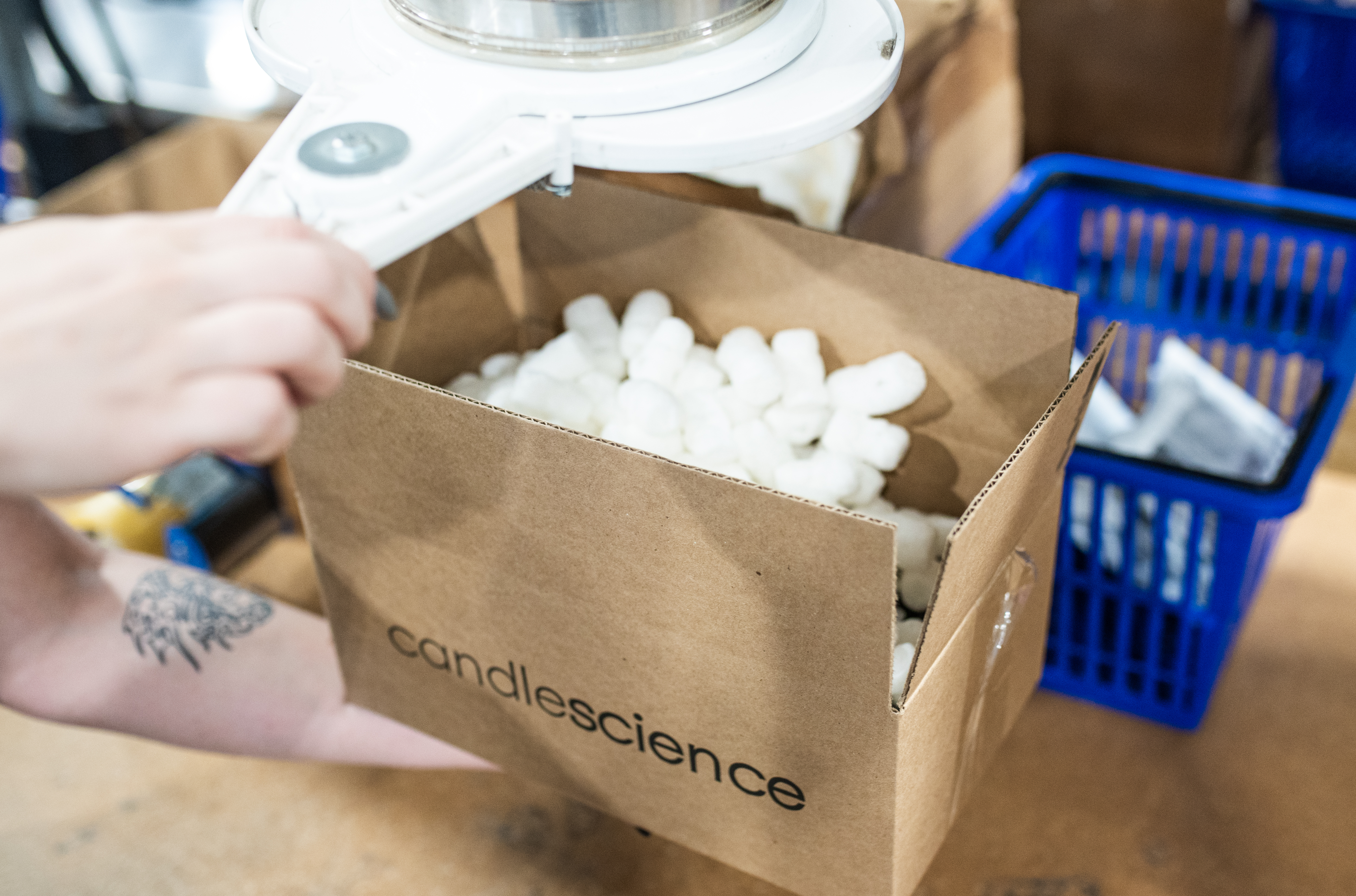 An order of CandleScience fragrance oils being packed for shipping.