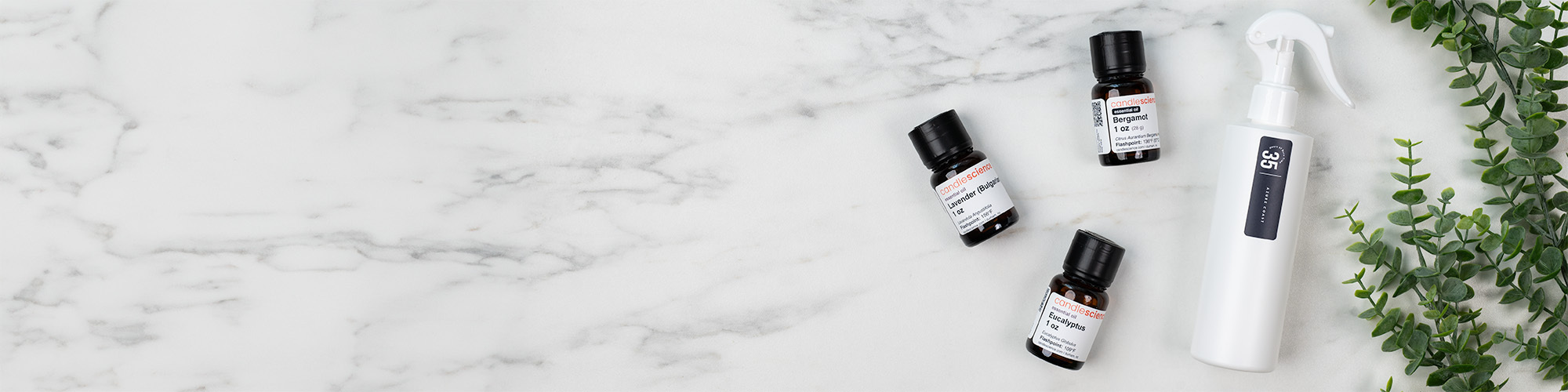 Essential oil bottles next to room spray bottle.