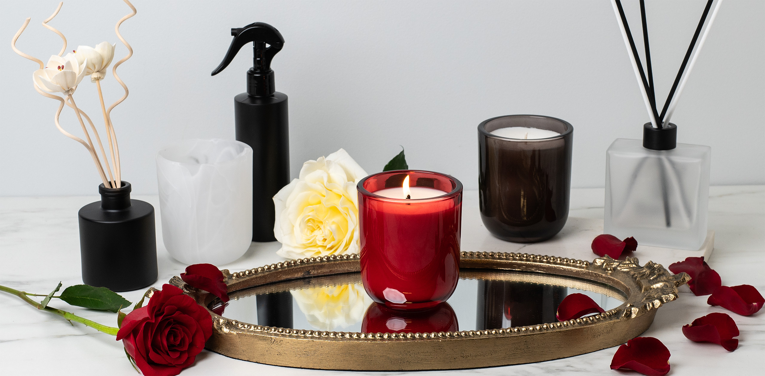 A Red Sonoma Tumbler Jar on a gold mirror.