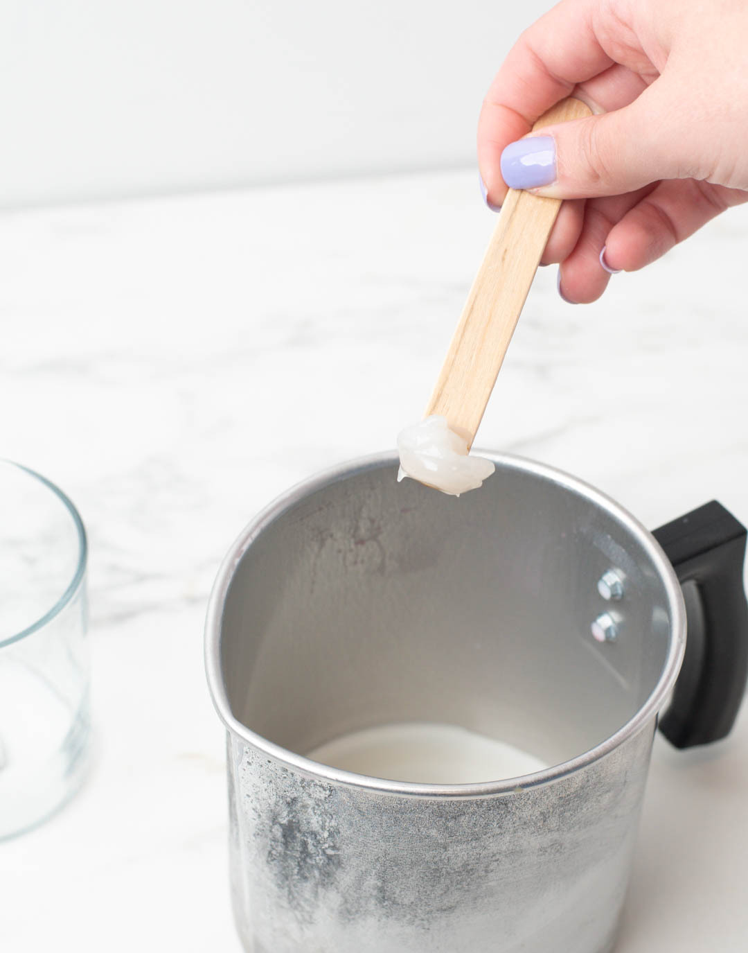 Correct consistency of cooled wax to make clouds in candle container.