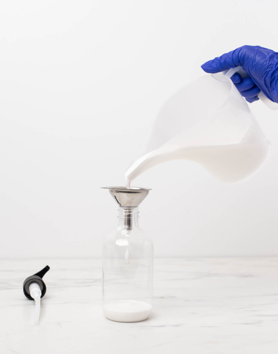 Hand tilting diffuser bottle with collar and stopper to show that it will not leak.