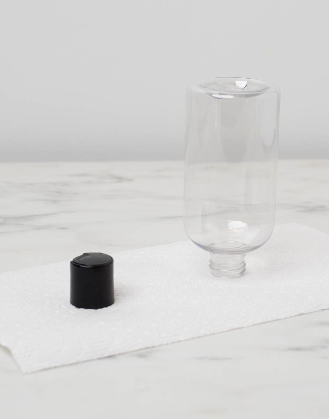 Glass beaker with fragrance oil in it on a scale reading 1.5 ounces.
