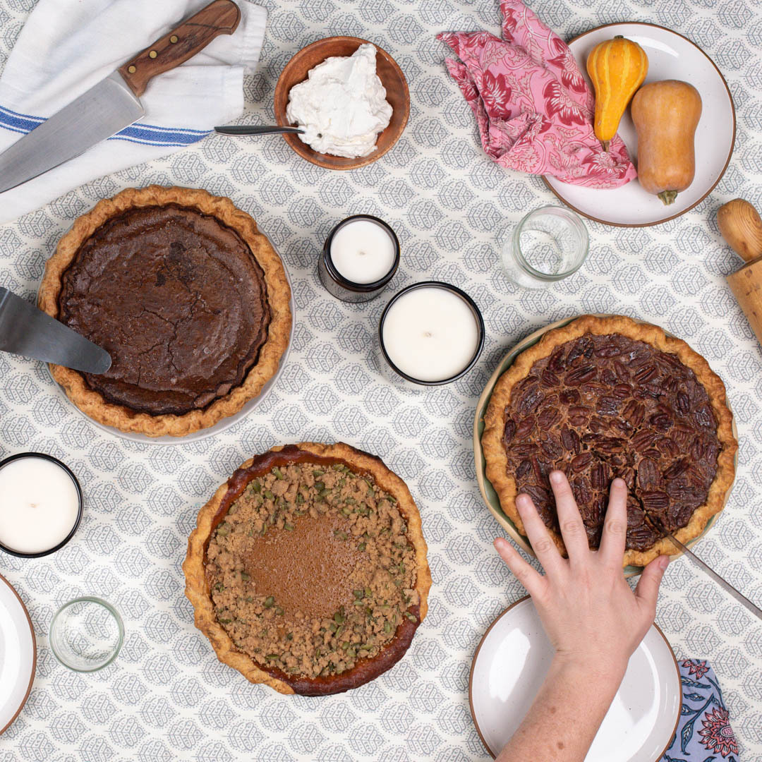 Cutting pie at a Thanksgiving table.