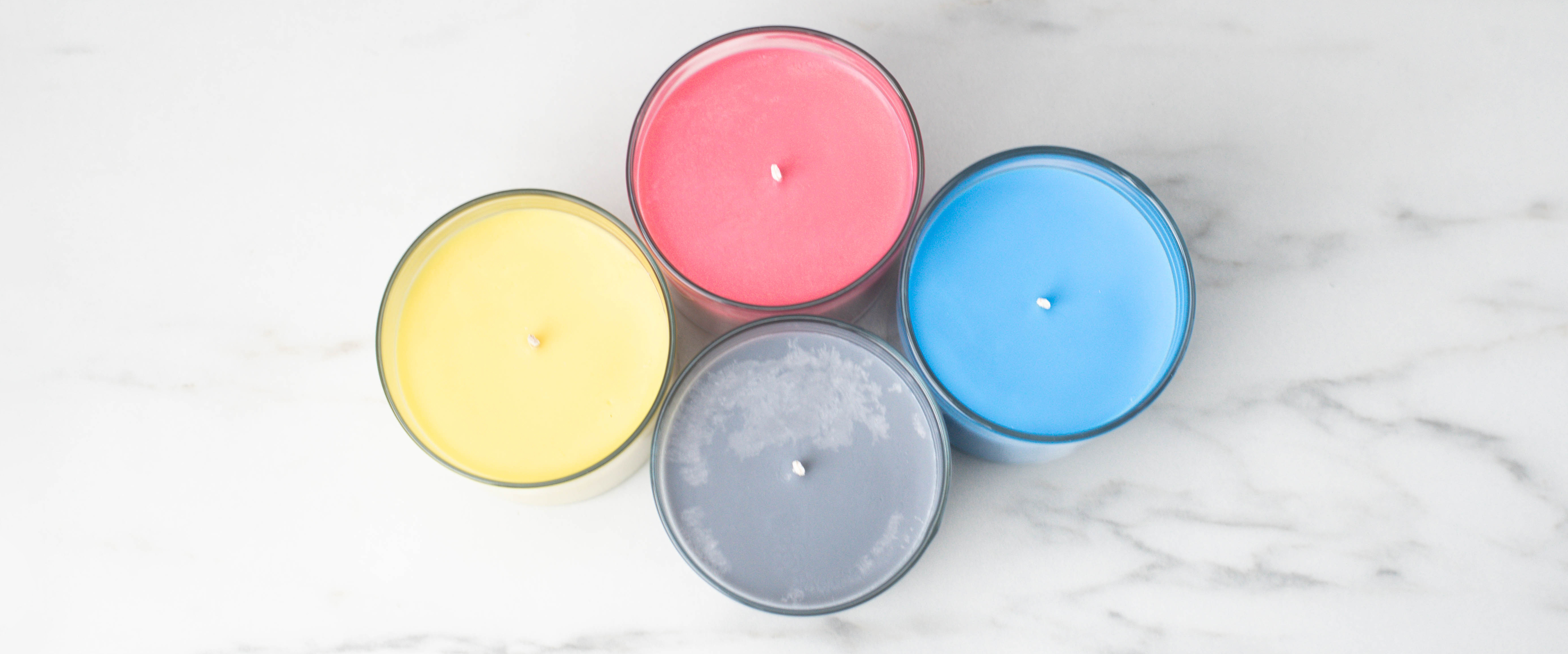 Dyed red, yellow, blue, and black (the black looks gray) candles using CandleScience SimplySoy™ Artisan Wax.