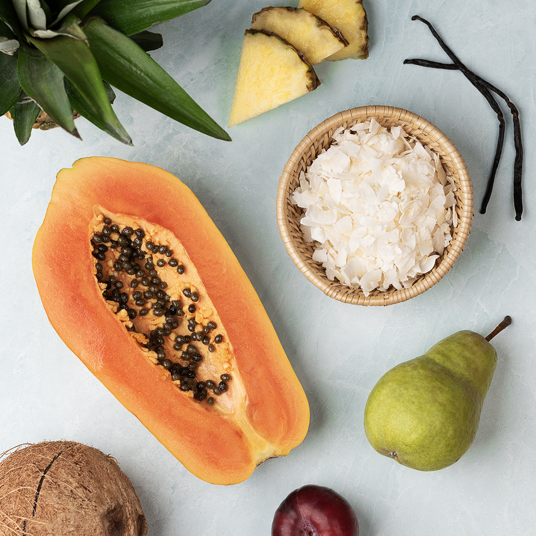 Top down view of rice, cardamom, and star anise on gray fabric.