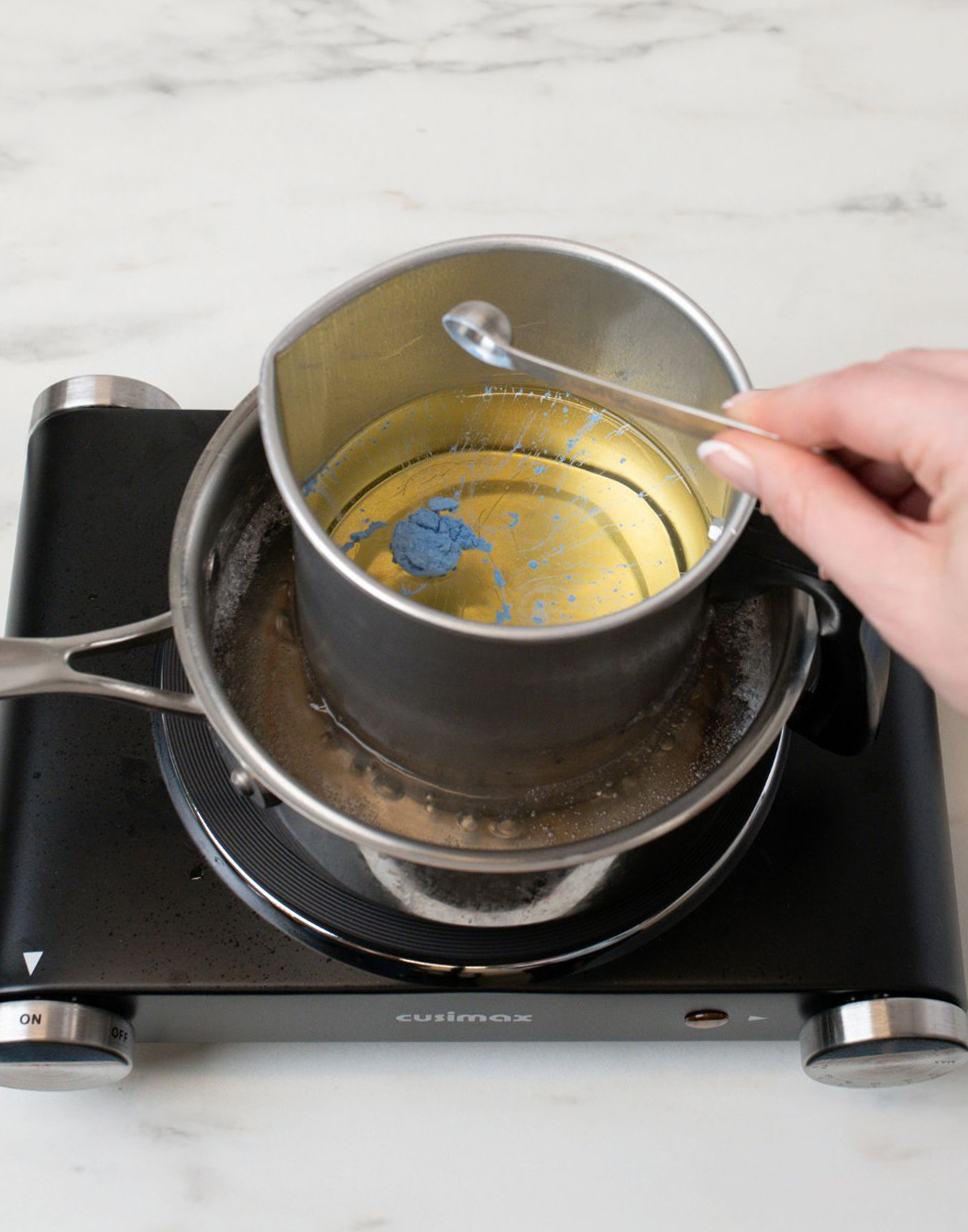 Adding mica powder into melted beeswax.