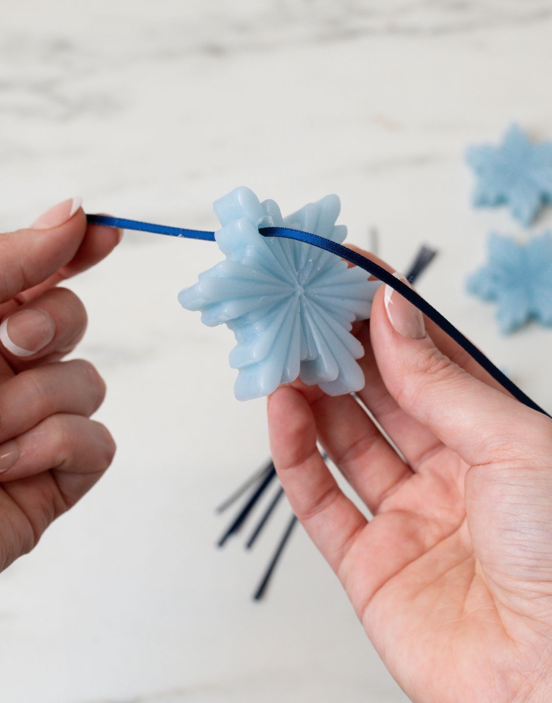Threading a beeswax Christmas tree ornament