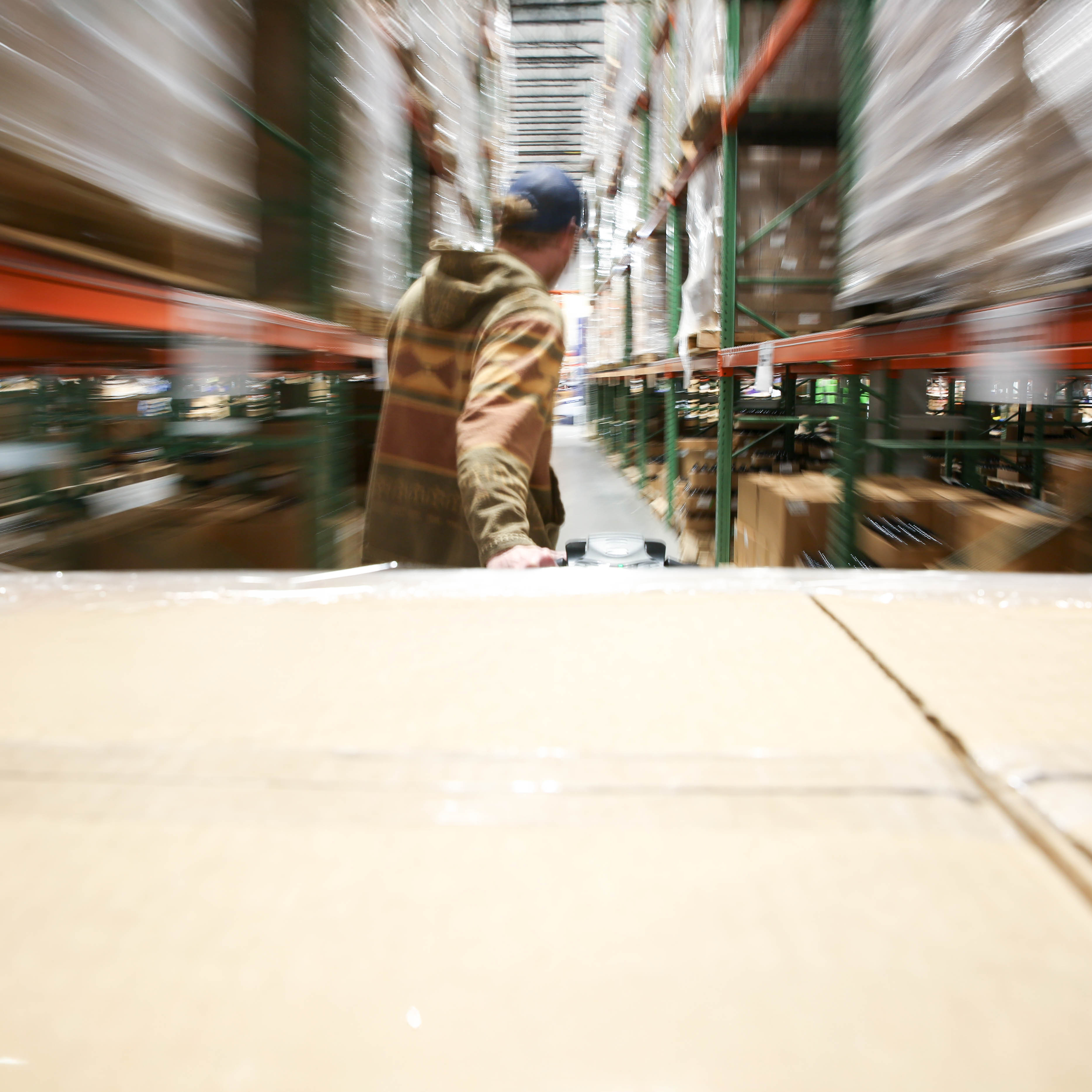 Pulling a pallet of boxes through a warehouse.