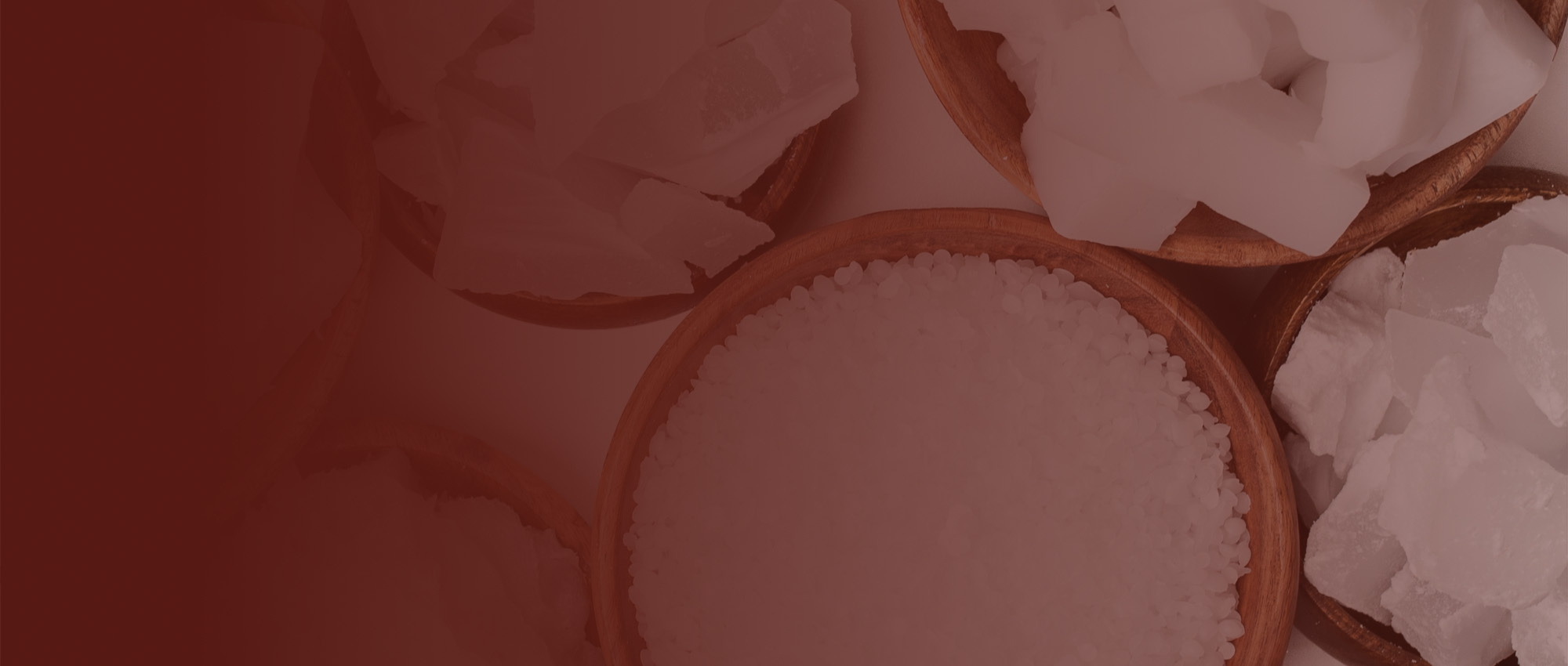 An overhead view of bowls of candle waxes