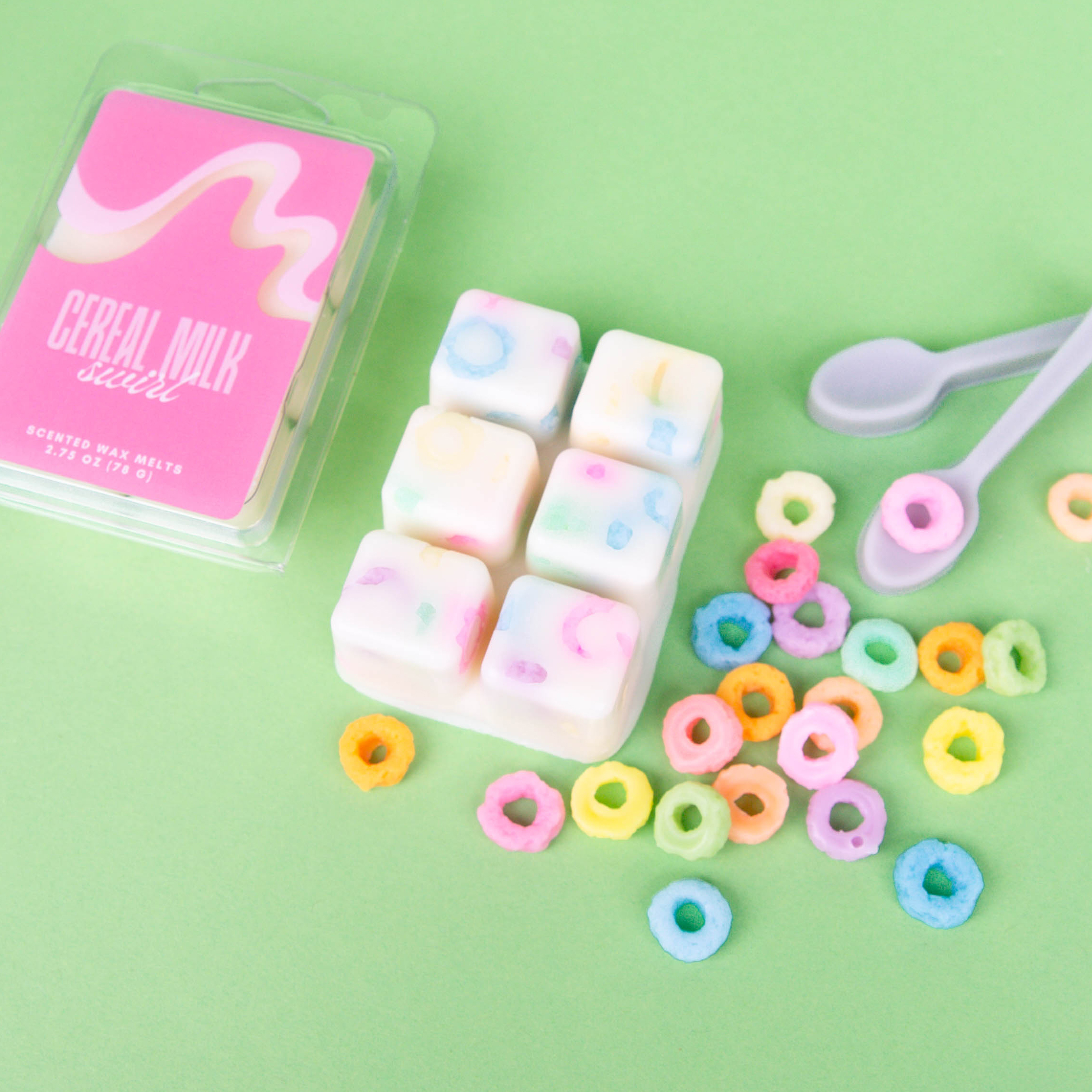 Multi-colored Candy heart wax melts being dropped into a wax warmer