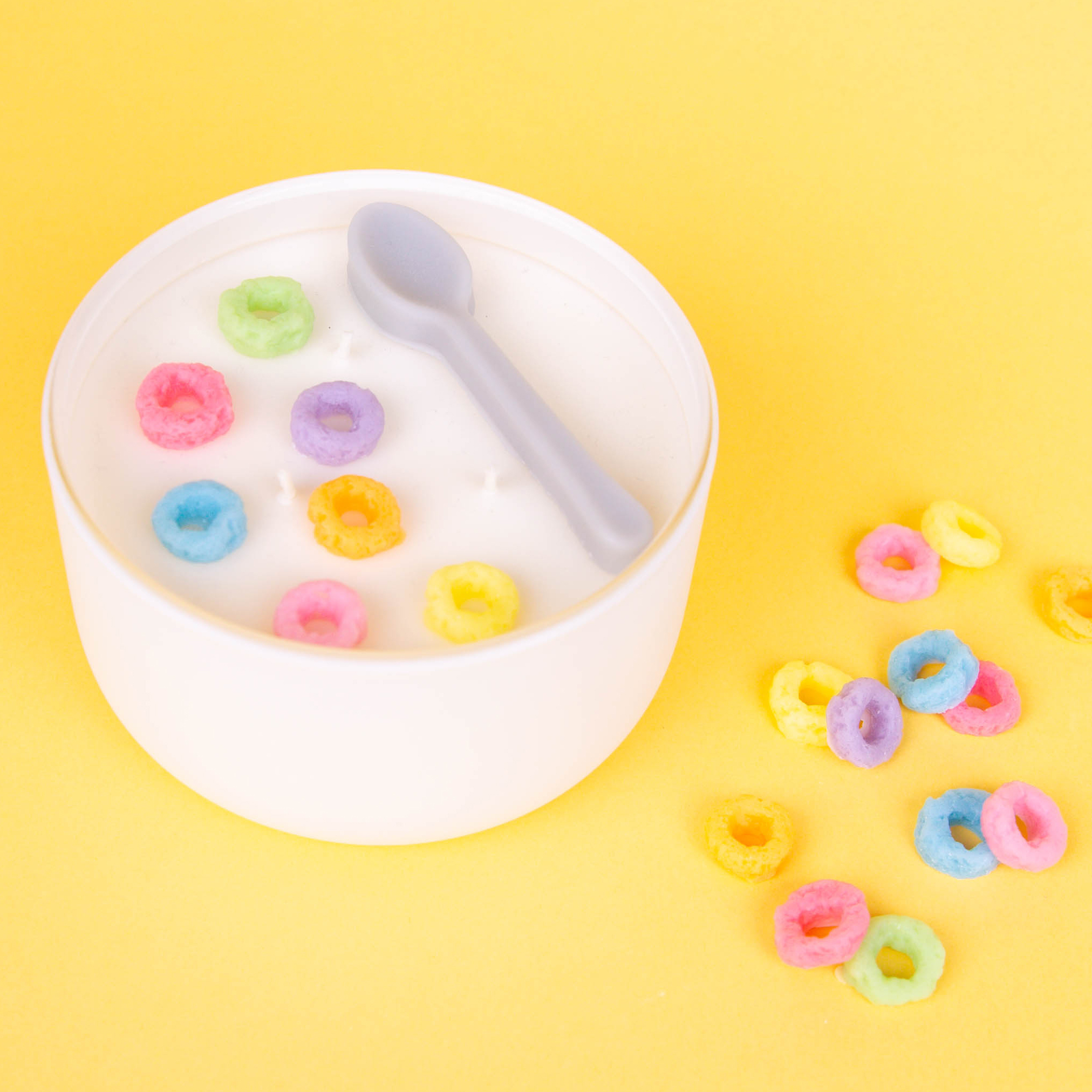 Small red heart wax melts placed in a heart mold half-filled with white wax