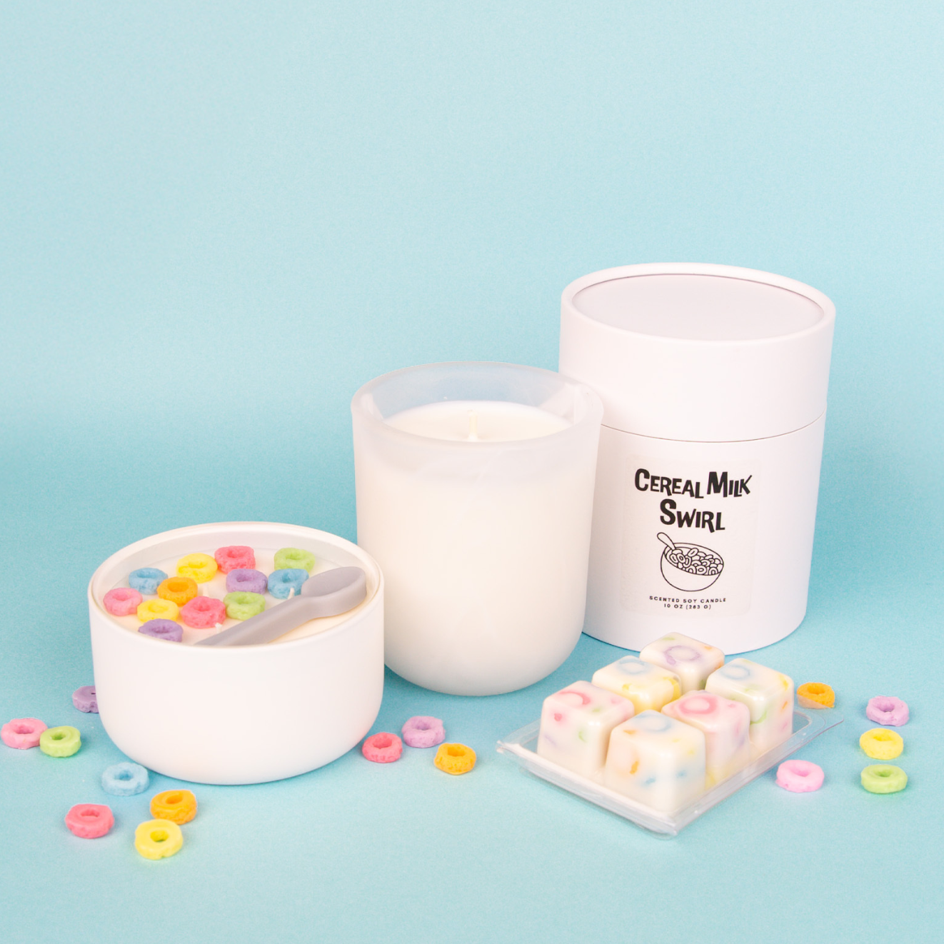 A hand lighting a pink mini candle with a match