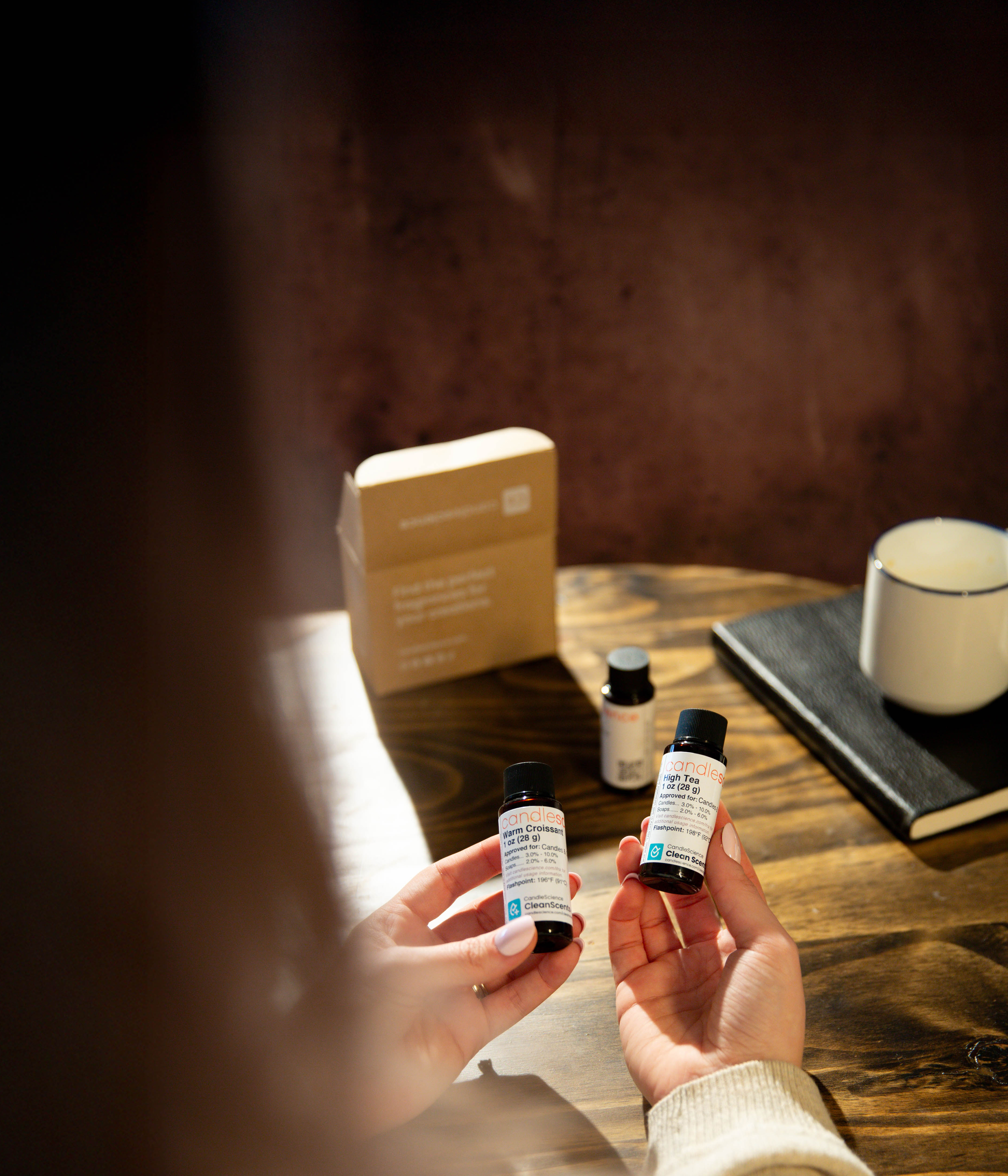 Holding 1 oz fragrance oil bottles from a fragrance flight collection.