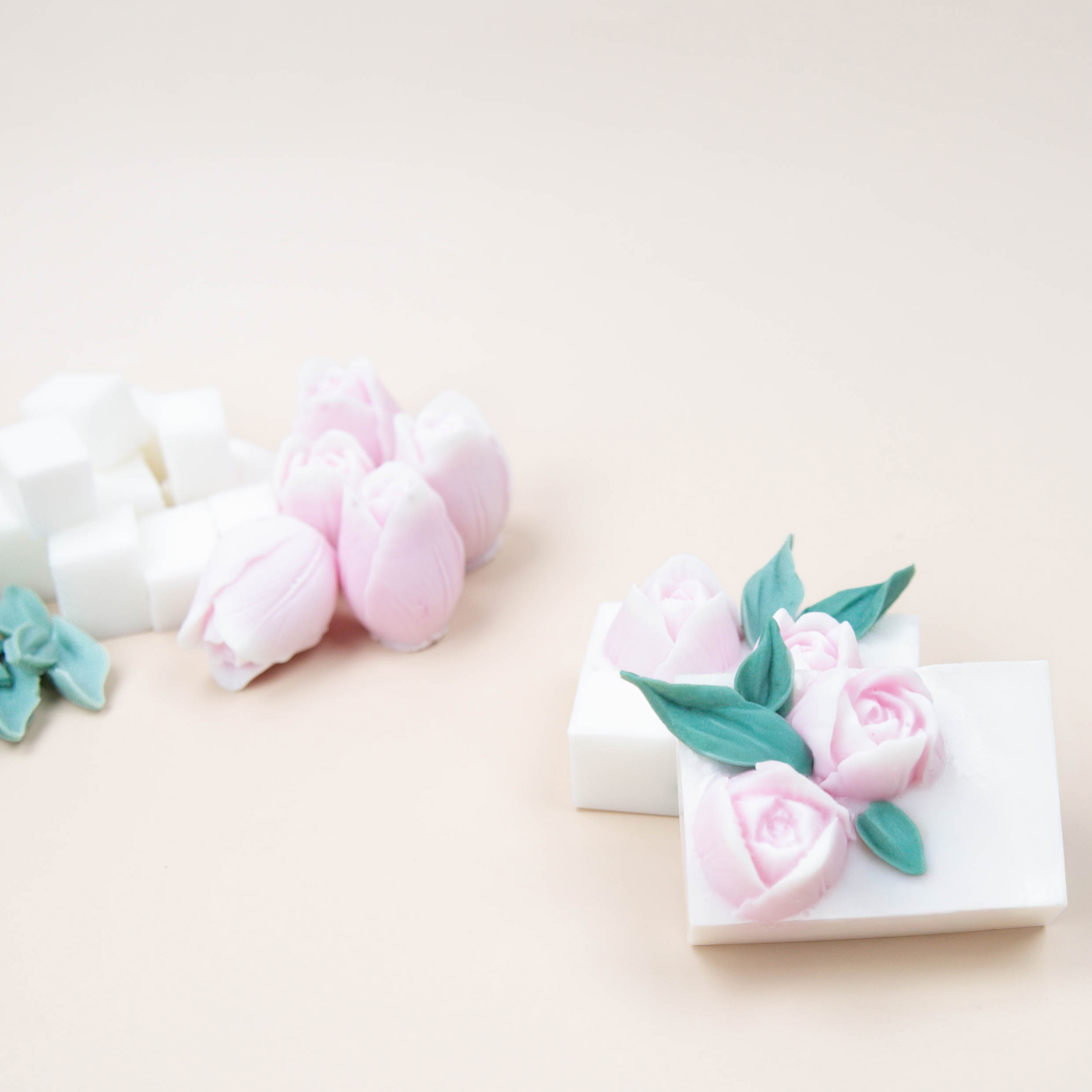 Small red heart wax melts placed in a heart mold half-filled with white wax