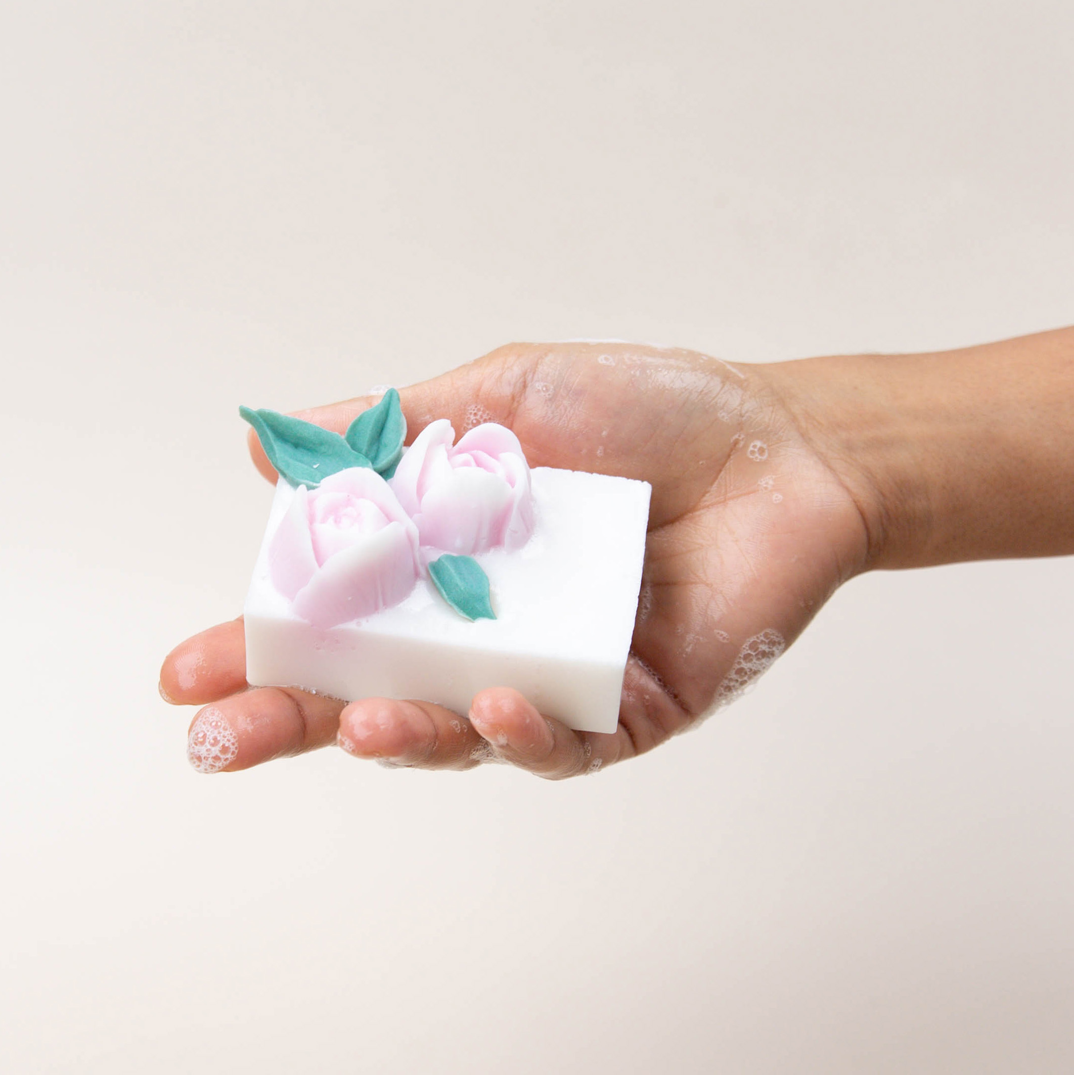 A white heart wax melt melting in a wax warmer revealing a hidden red swirl of dye