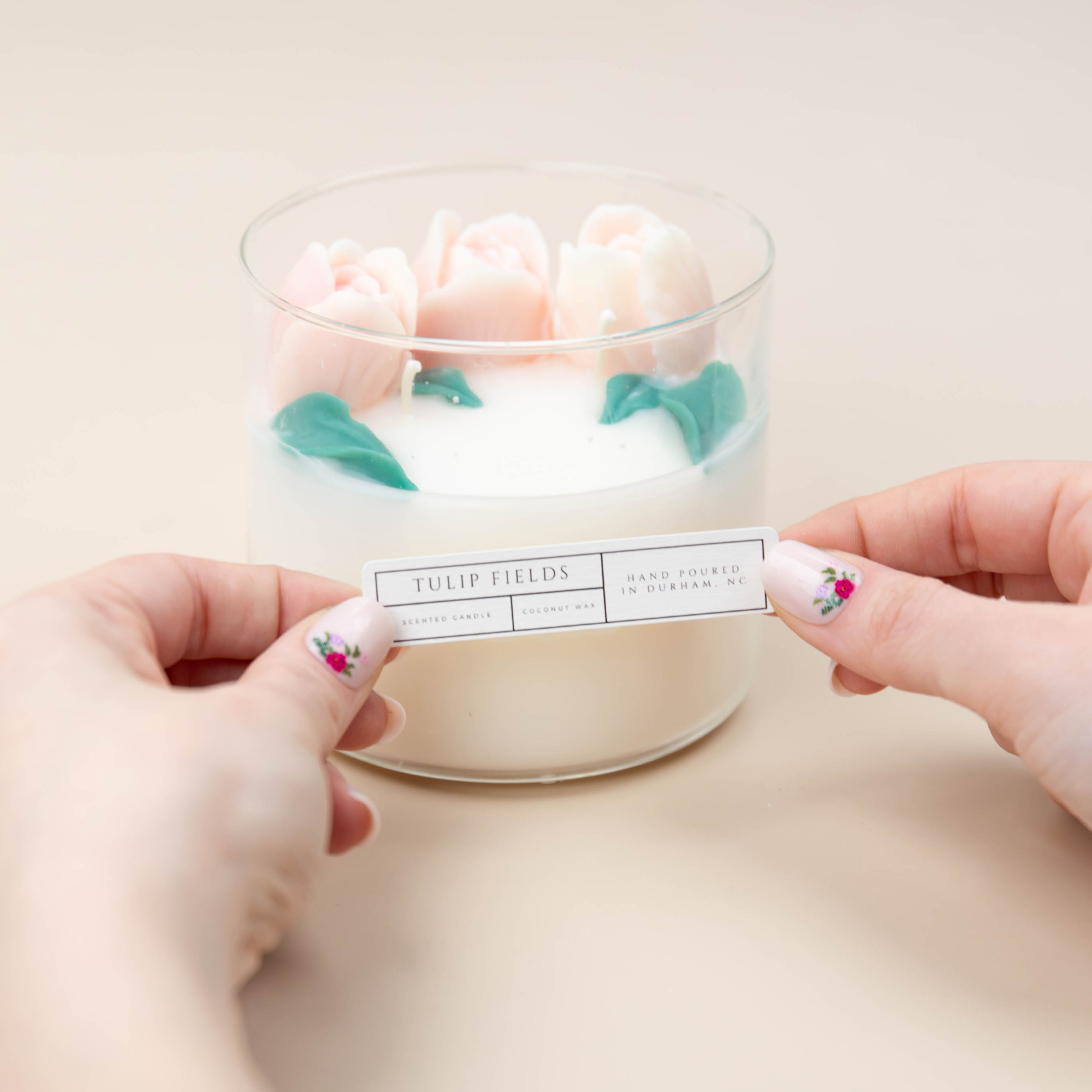 Placing a label on the floral embed candle.