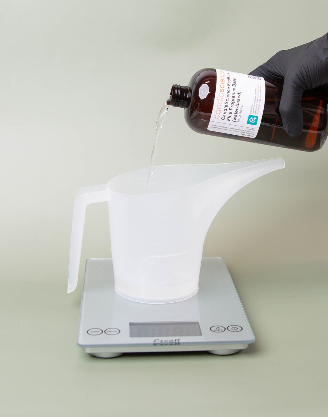 Pouring EcoBase into a funnel pouring pticher on a scale.