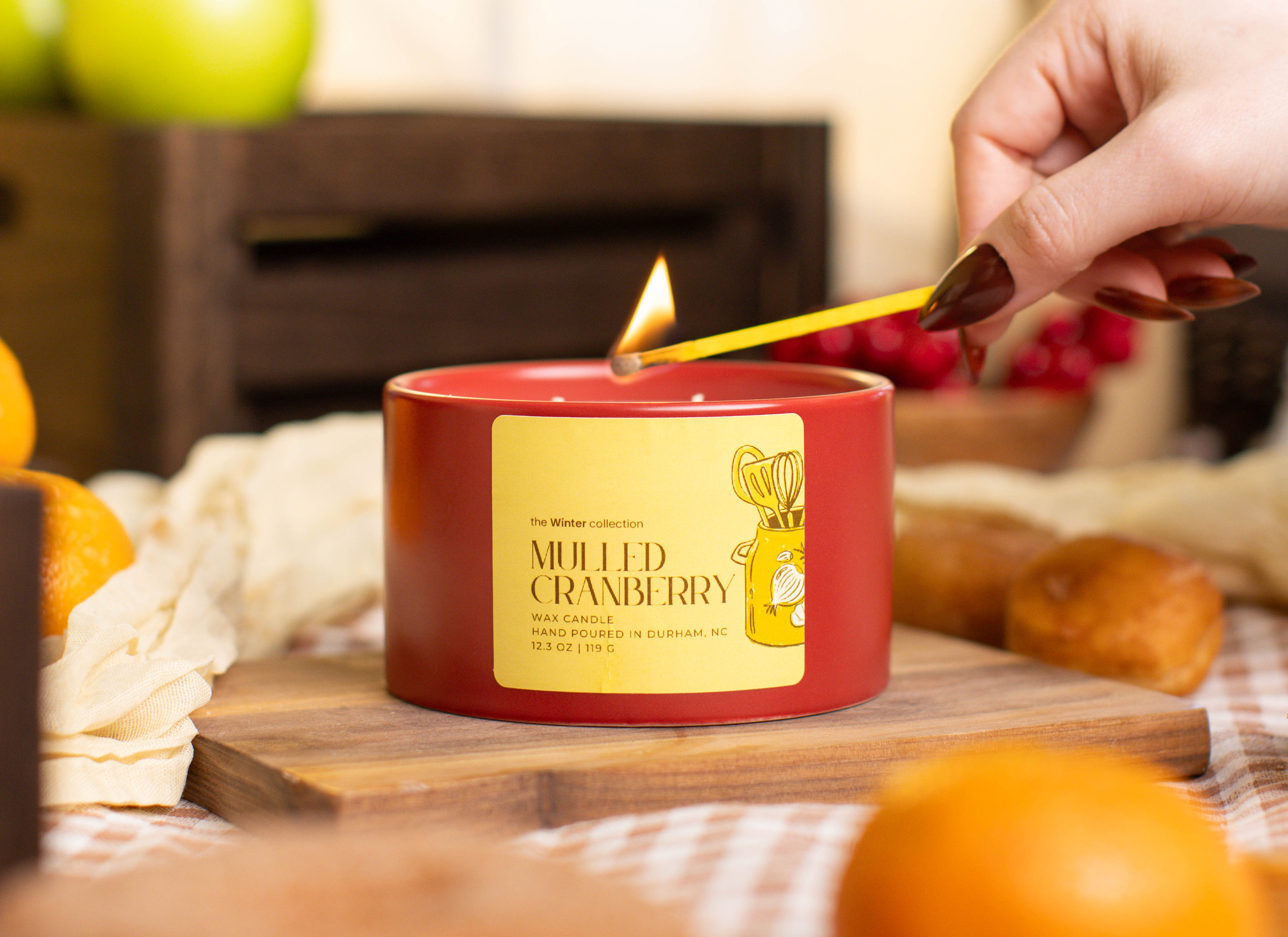 Harvest Kitchen candle being lit.