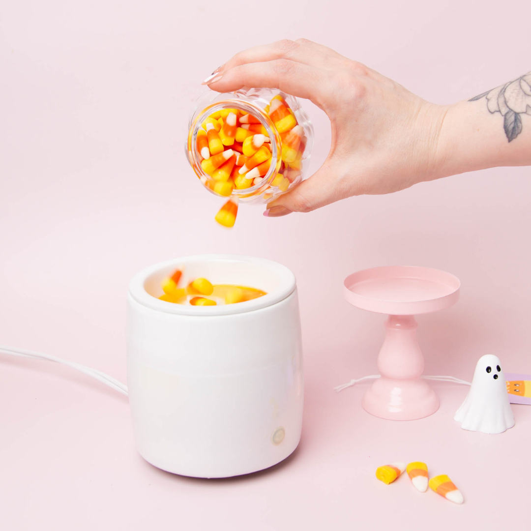 Candy corn wax melts being poured into a wax melter.