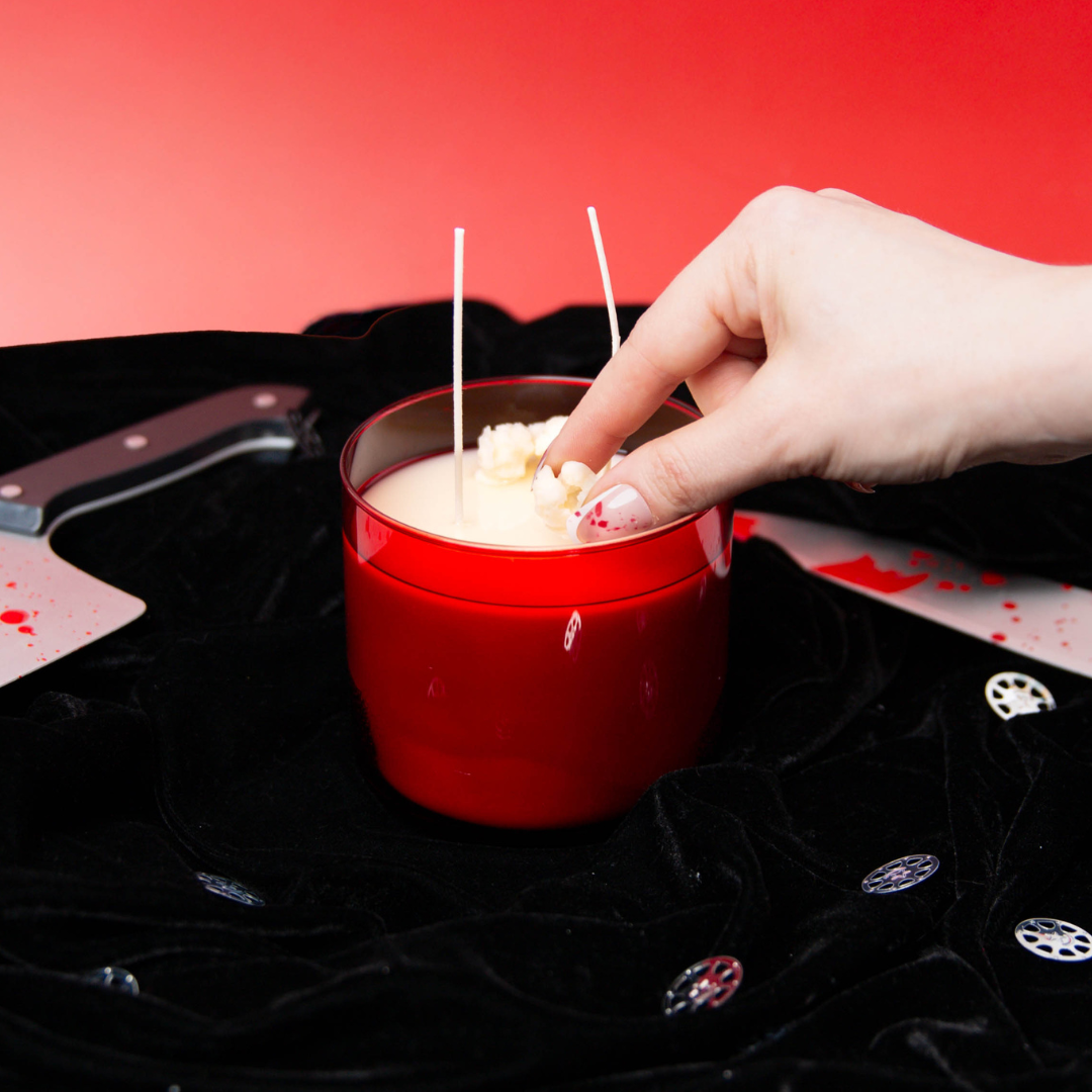 Adding wax popcorn embeds to a candle.