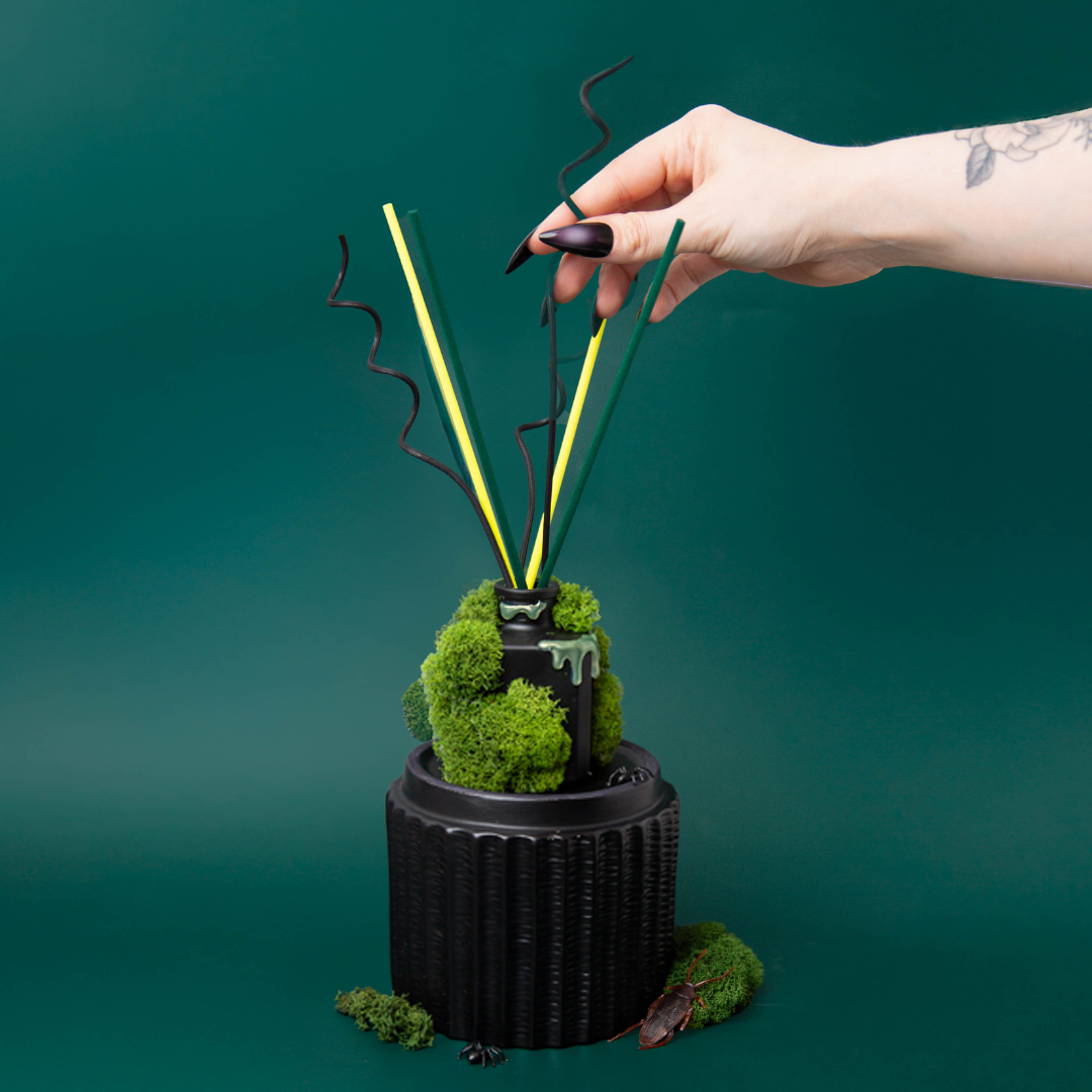 Adding colored reed diffusers to a moss covered reed diffuser bottle.