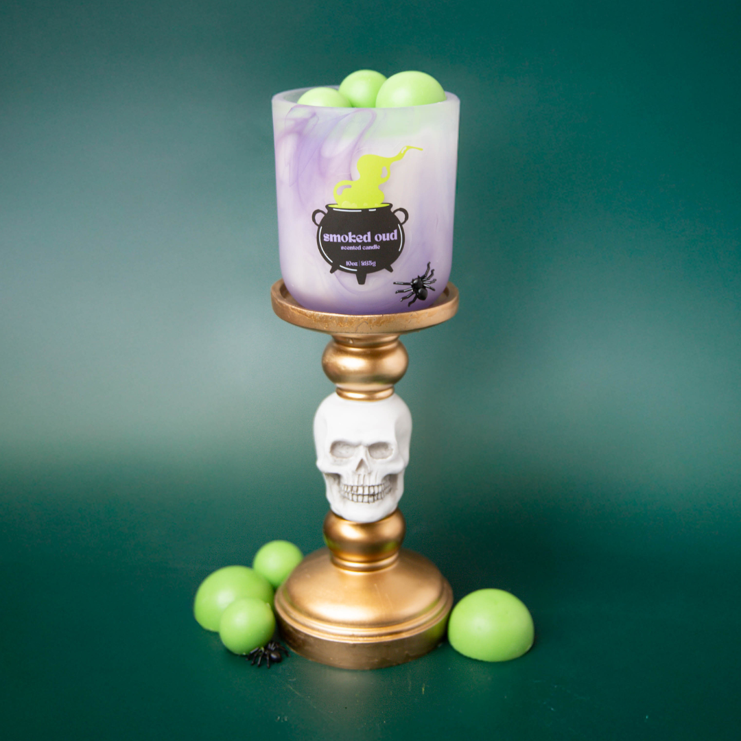 Purple swirl candle container with green bubble embeds.