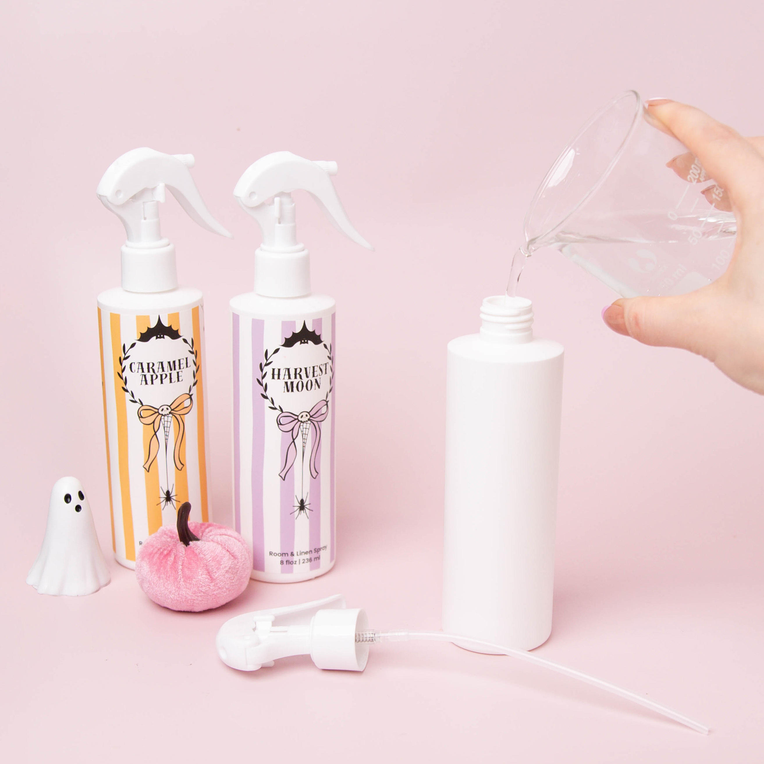 Pouring Room and Linen Spray solution into an HDPE bottle.