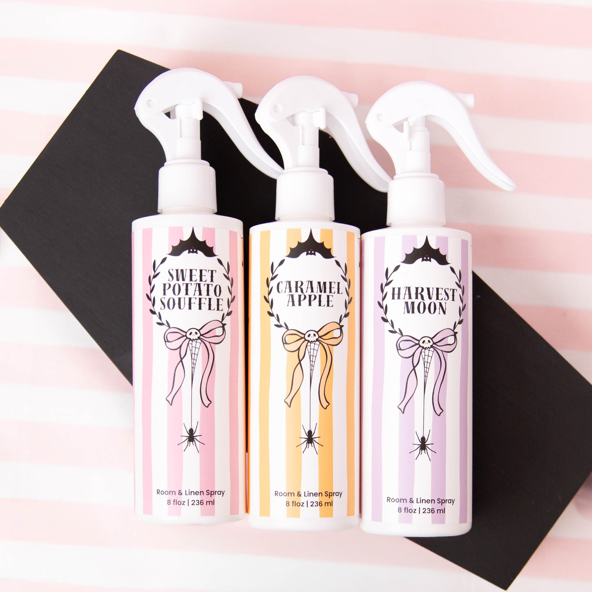 Top down image of three room and linen sprays with Halloween themed labels.