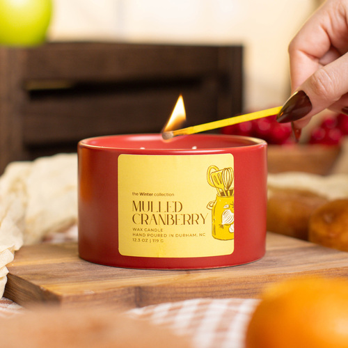 Harvest Kitchen candle being lit.