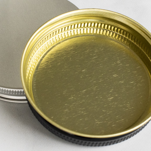 Threaded metal lid closeup.