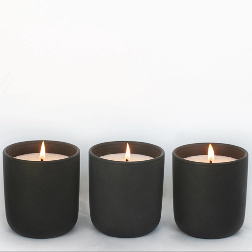 Black Tumbler Candle on table. 