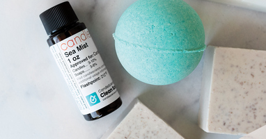 1 oz bottle of sea mist fragrance oil with a blue bath bomb and soap
