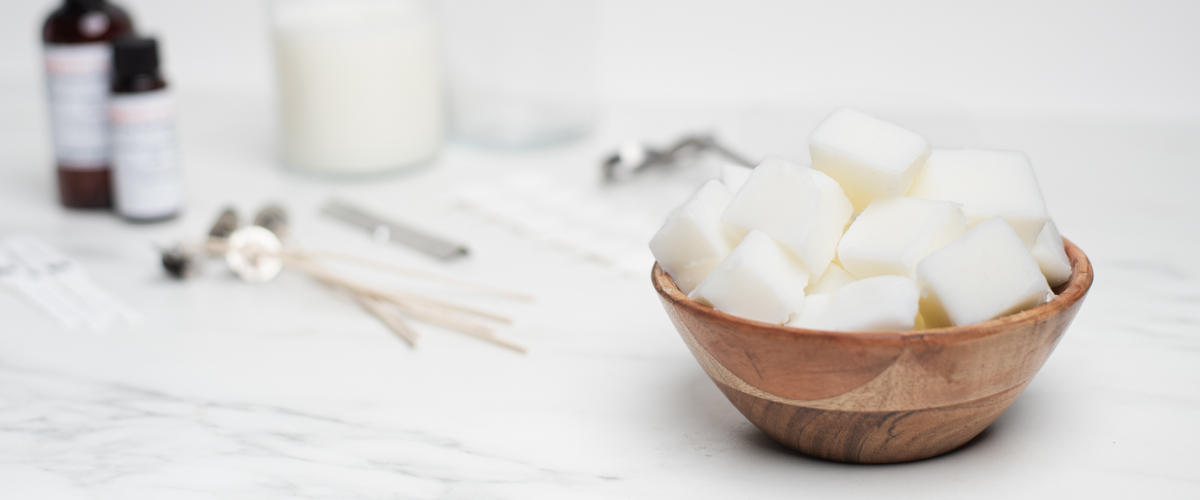 A wooden bowl of CandleScience Coconut Apricot Wax in cubes