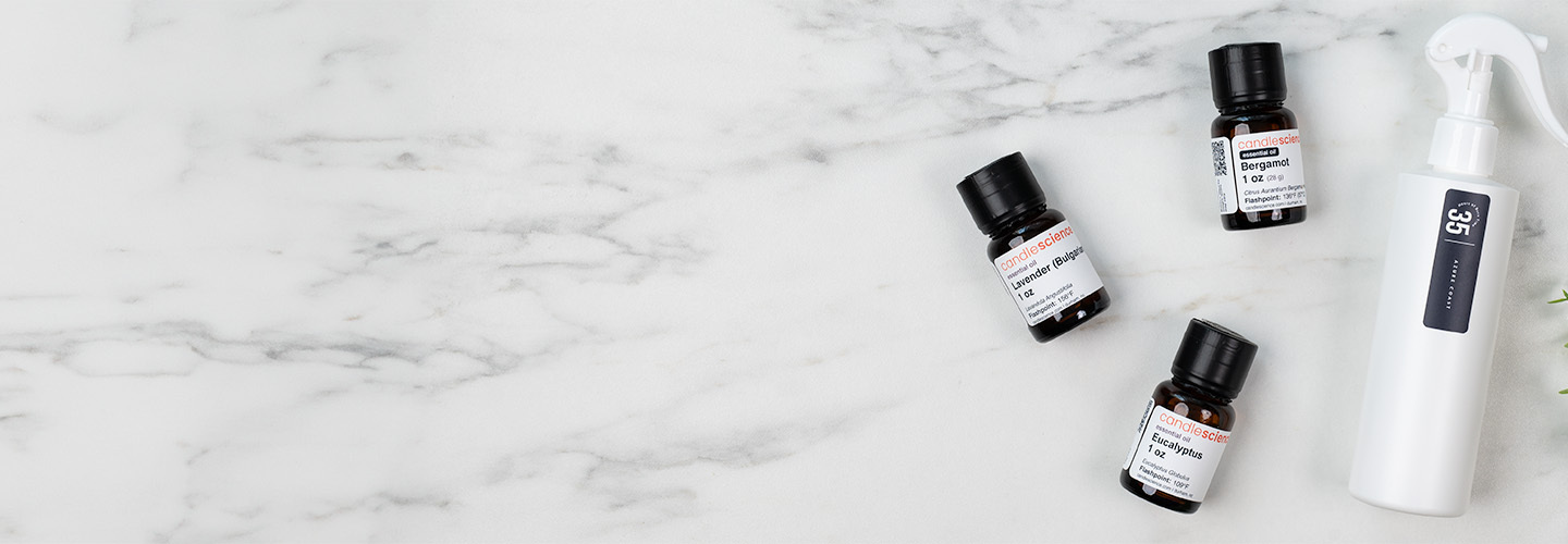 Essential oil bottles next to room spray bottle.