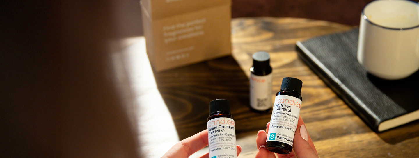 Holding 1 oz fragrance oil bottles from a fragrance flight collection.